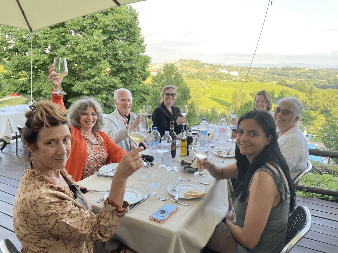 A group of people sitting at a table with wine glasses.